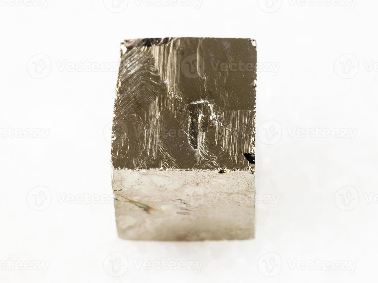 rough pyrite crystal on white marble photo