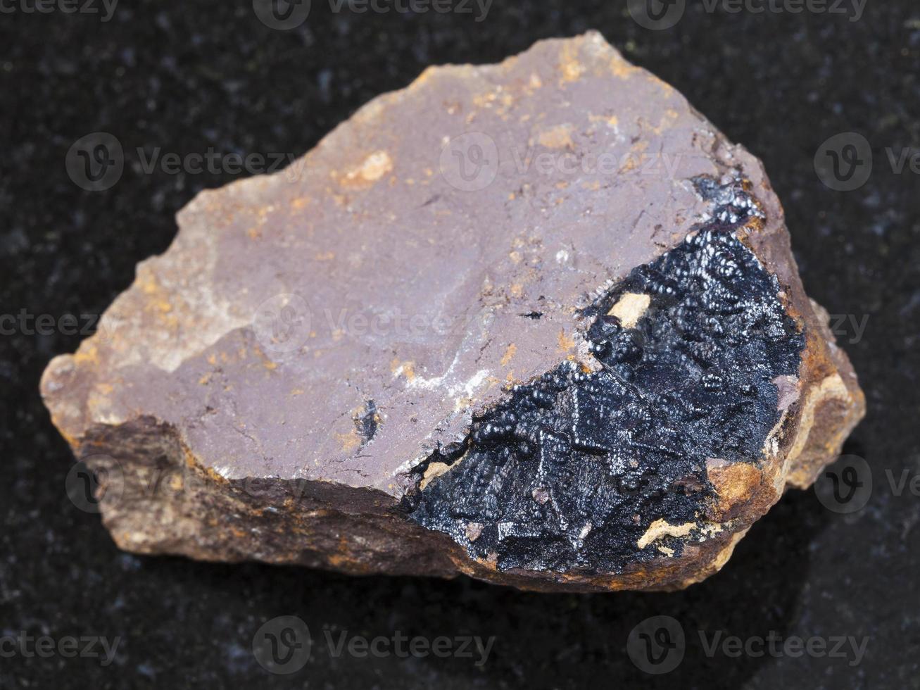goethite aggregates on limonite rock on dark photo