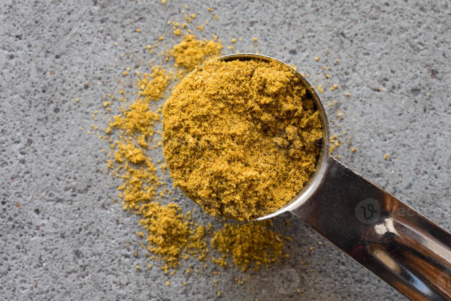 Curry Powder Spilled from a Teaspoon photo