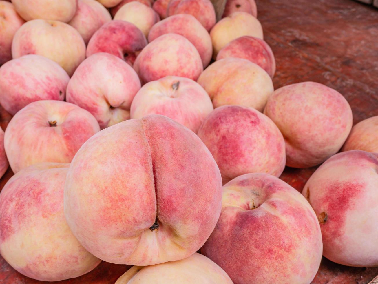 Close up chinese peach fruits on the basket in the fruits store at china photo