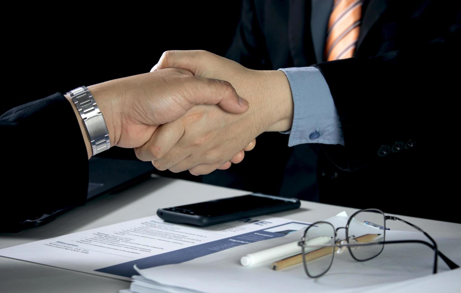 businessman and job seeker shake hands after agreeing to accept job and approve him employee at company. or joint venture agreement between two business. Concept of recruitment, successful negotiation photo