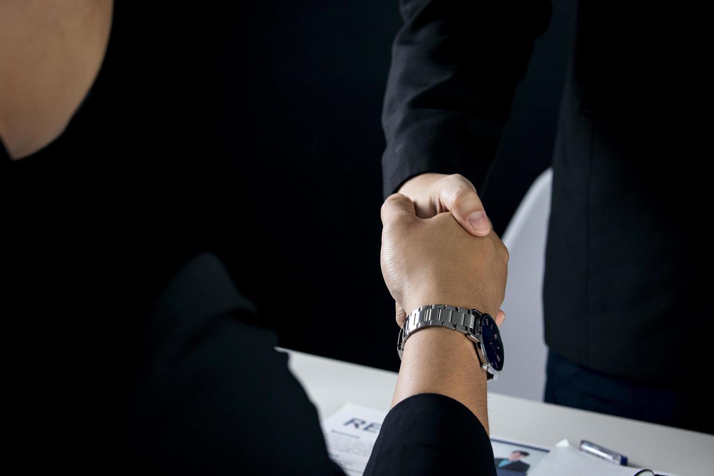 businessman and job seeker shake hands after agreeing to accept job and approve him employee at company. or joint venture agreement between two business. Concept of recruitment, successful negotiation photo