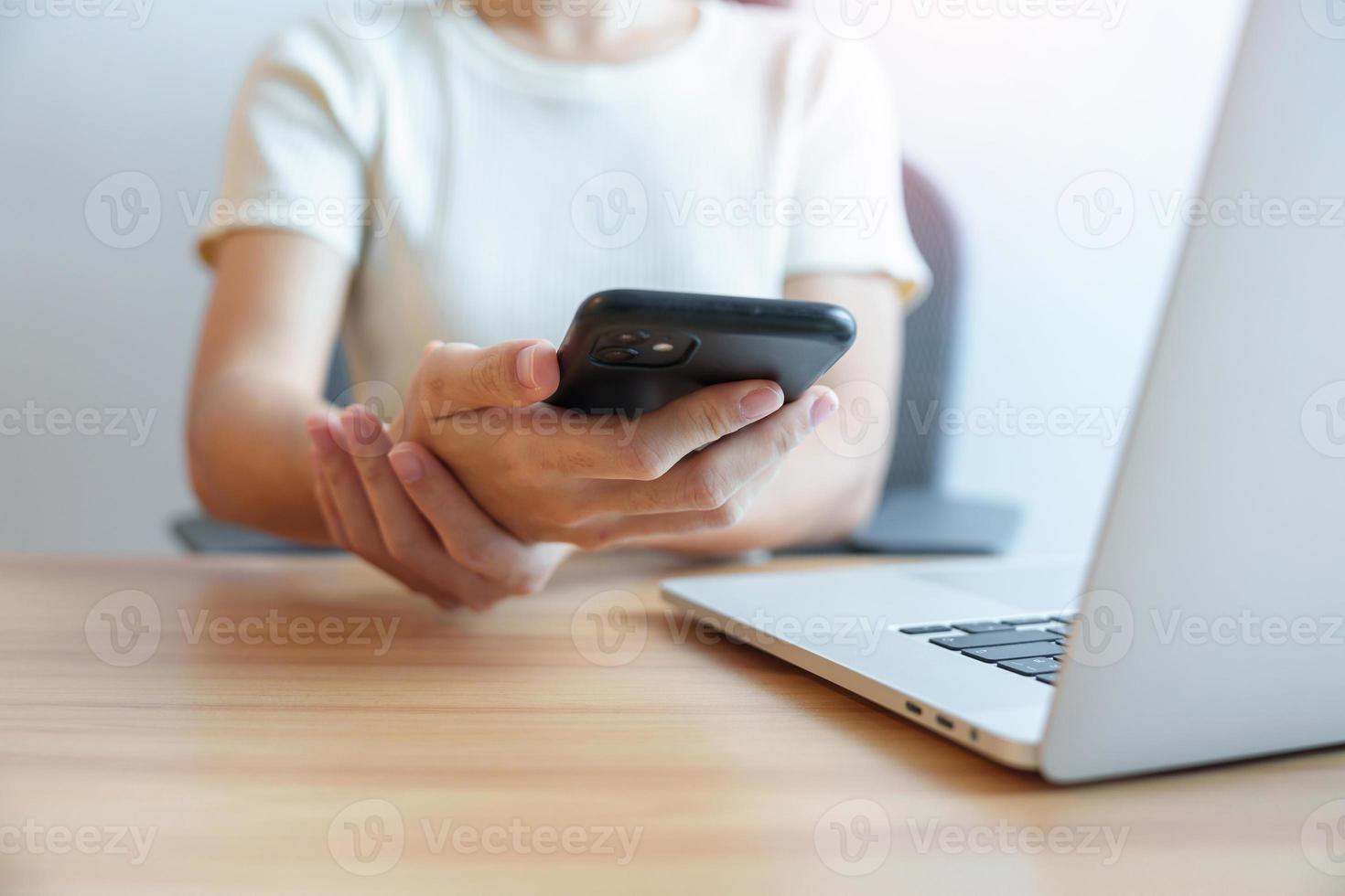 Woman having wrist pain when using mobile phone during working long time on workplace. De Quervain s tenosynovitis, ergonomic, Carpal Tunnel Syndrome or Office syndrome concept photo