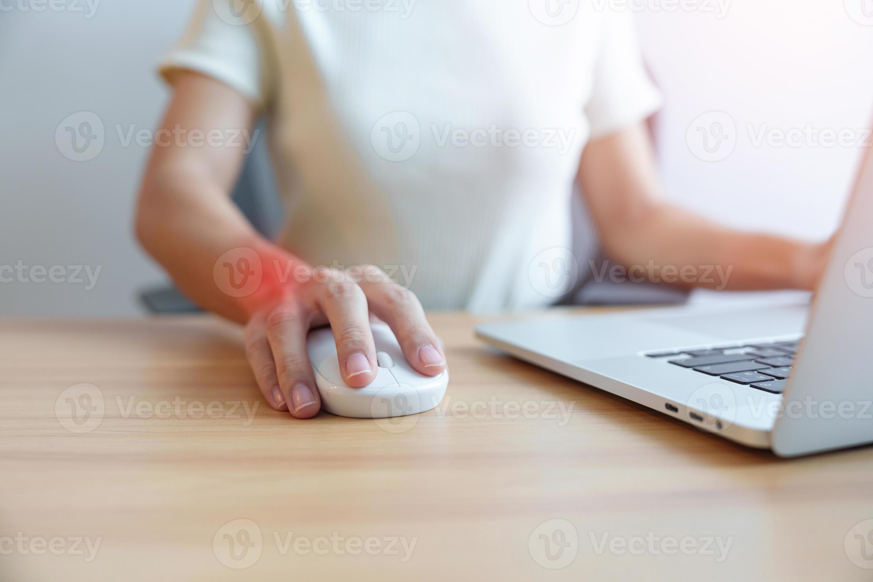 Woman having wrist pain when using mouse during working long time on workplace. De Quervain s