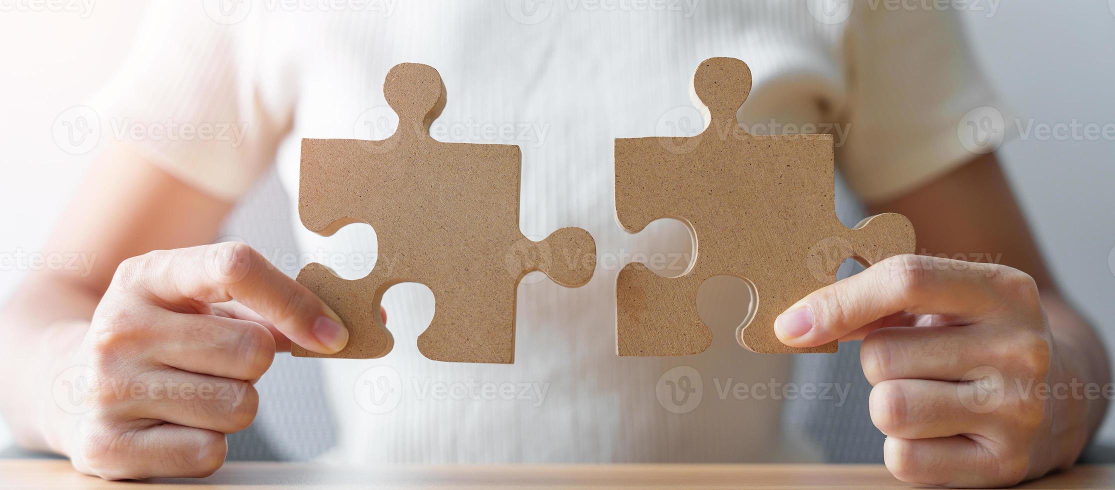 Hand connecting couple puzzle piece. Business Solving, mission, challenge, success, goals, target and strategy concepts photo