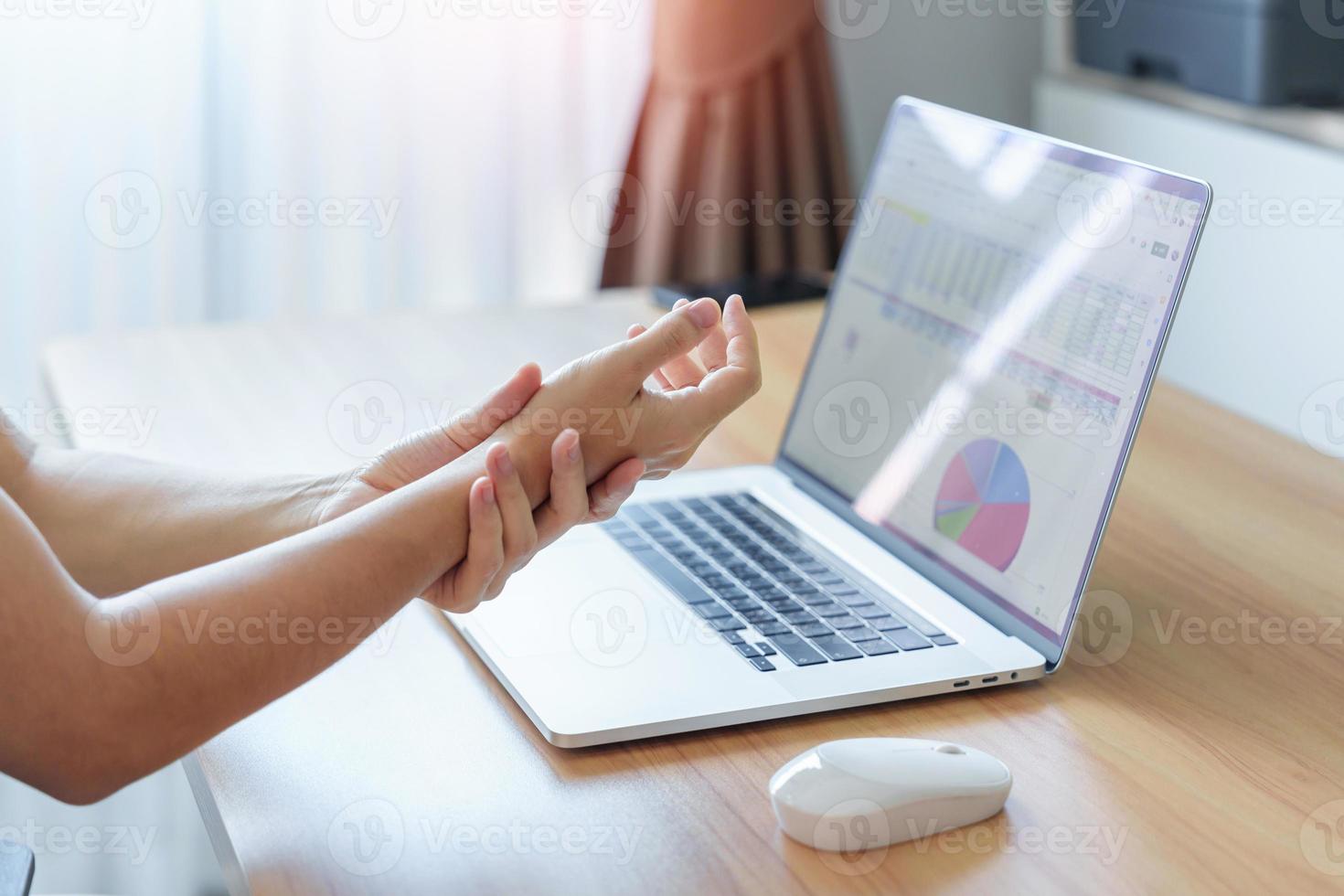 Woman having wrist pain when using mouse during working long time on workplace. De Quervain s tenosynovitis, ergonomic, Carpal Tunnel Syndrome or Office syndrome concept photo