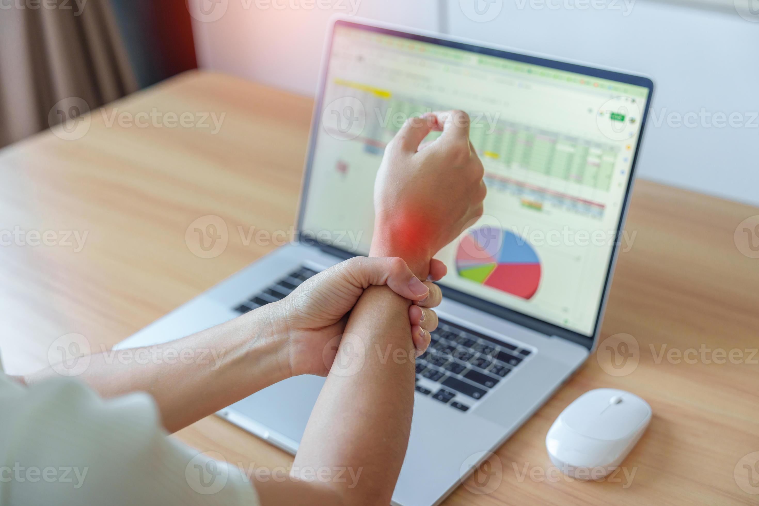 Woman having wrist pain when using mouse during working long time on workplace. De Quervain s