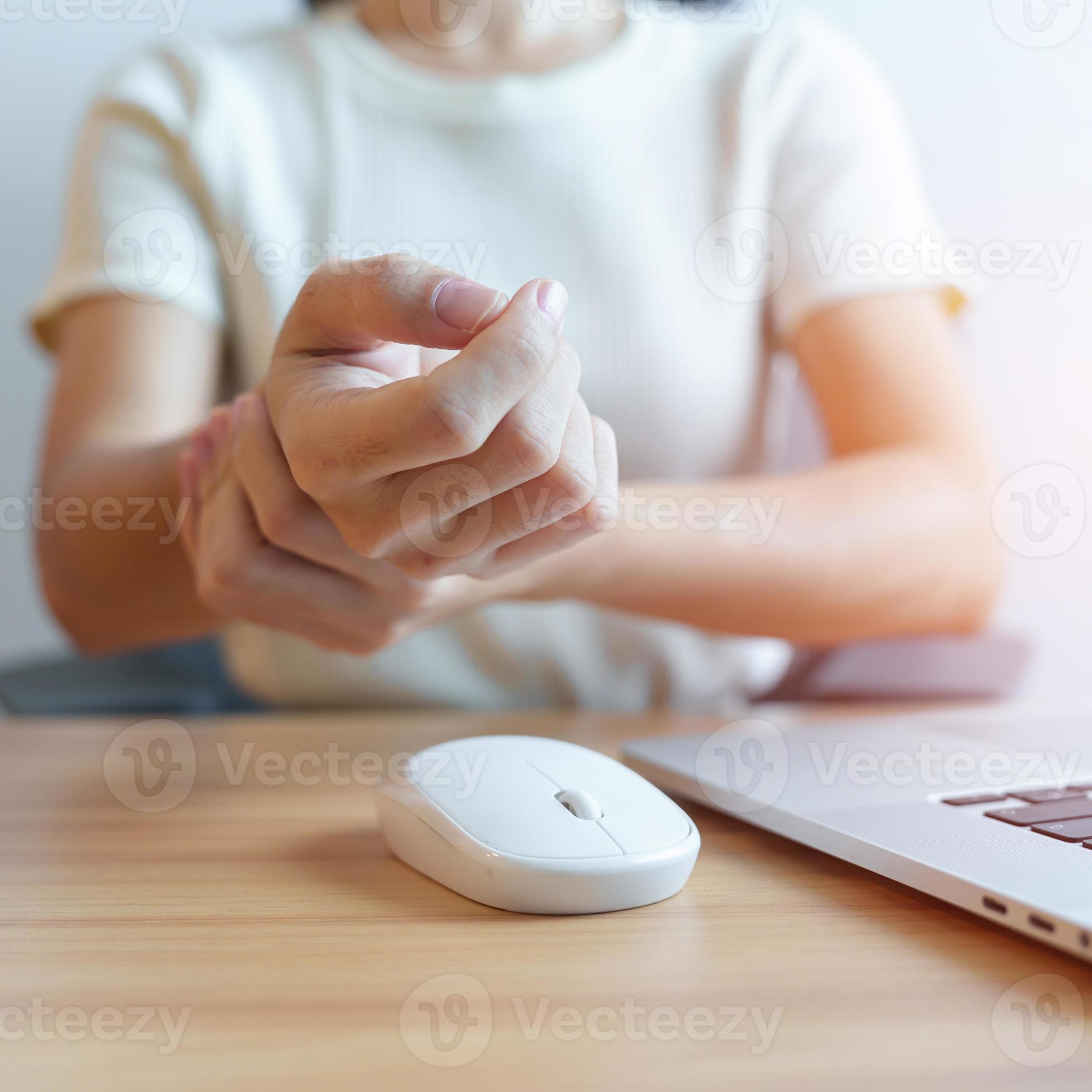 Woman having wrist pain when using mouse during working long time on workplace. De Quervain s