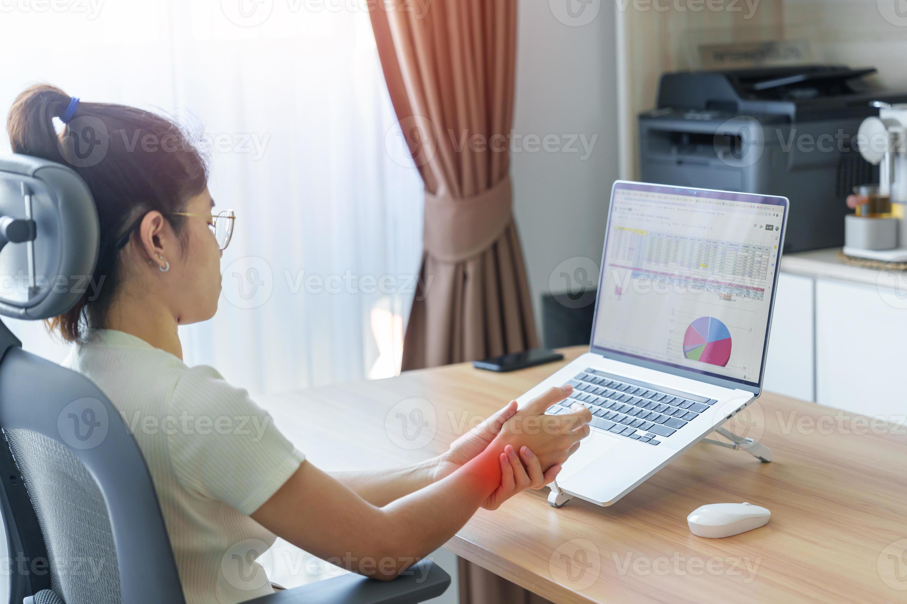 Woman having wrist pain when using mouse during working long time on workplace. De Quervain s