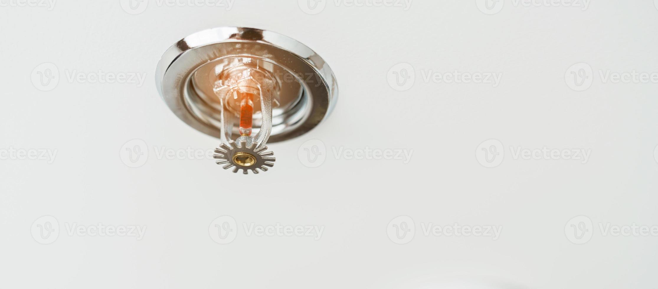 Fire Sprinkler detector mounted on roof in home or apartment. Safety and conflagration security concept photo