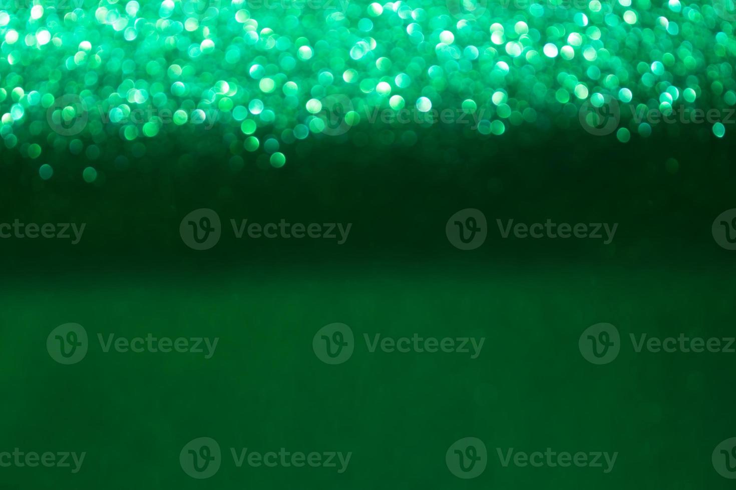 Green shiny blurred bokeh background. Christmas, New Year, Spring or Summer Holidays. Copy space photo