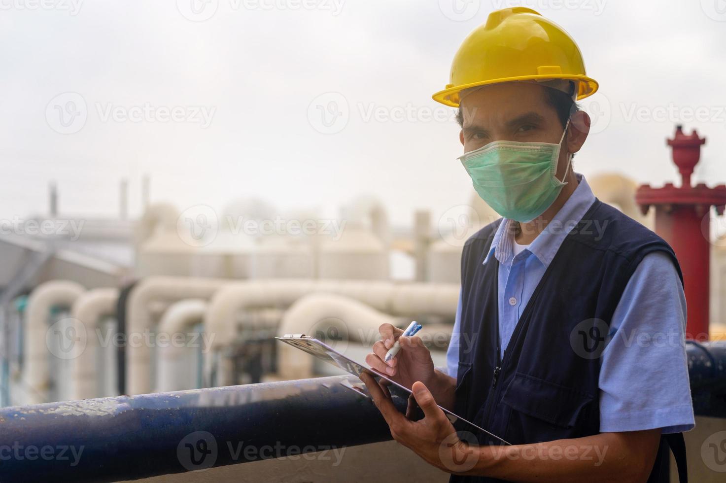 Engineers write industrial factory inspection reports. photo