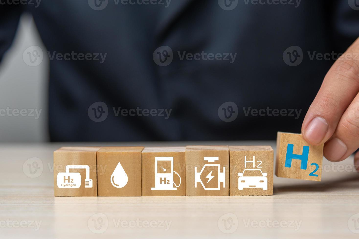 Hydrogen fuel is used to replace carbon dioxide, helping to reduce global warming. wood cube icon H2 hydrogen. photo