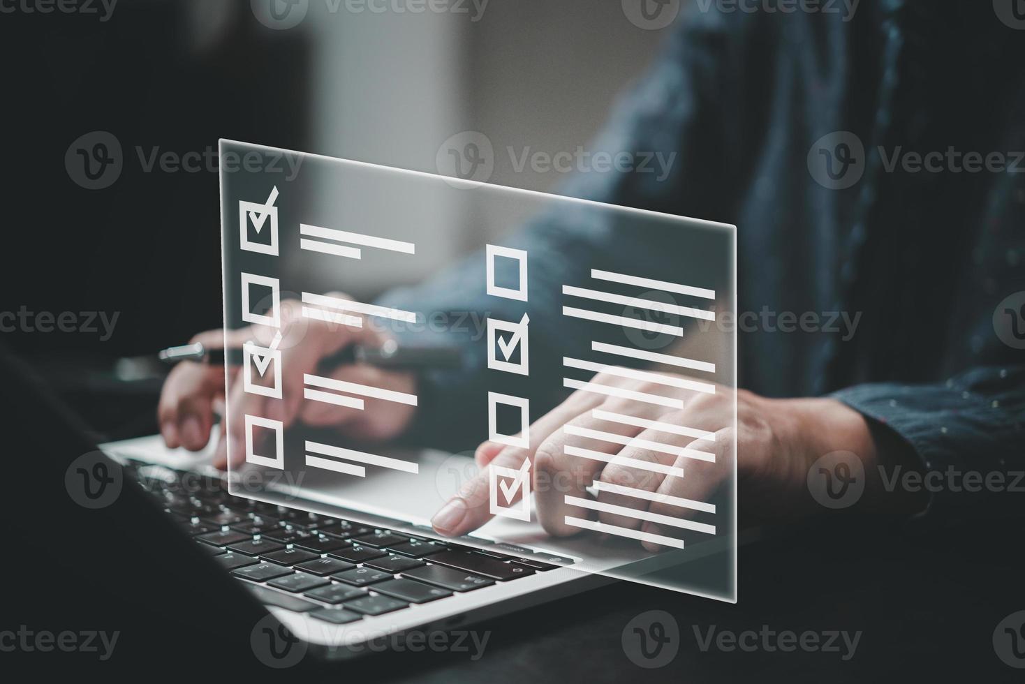 man using laptop questionnaire with checkbox, survey form online, answer questions in the exam of test business checklist and filling survey form online. photo