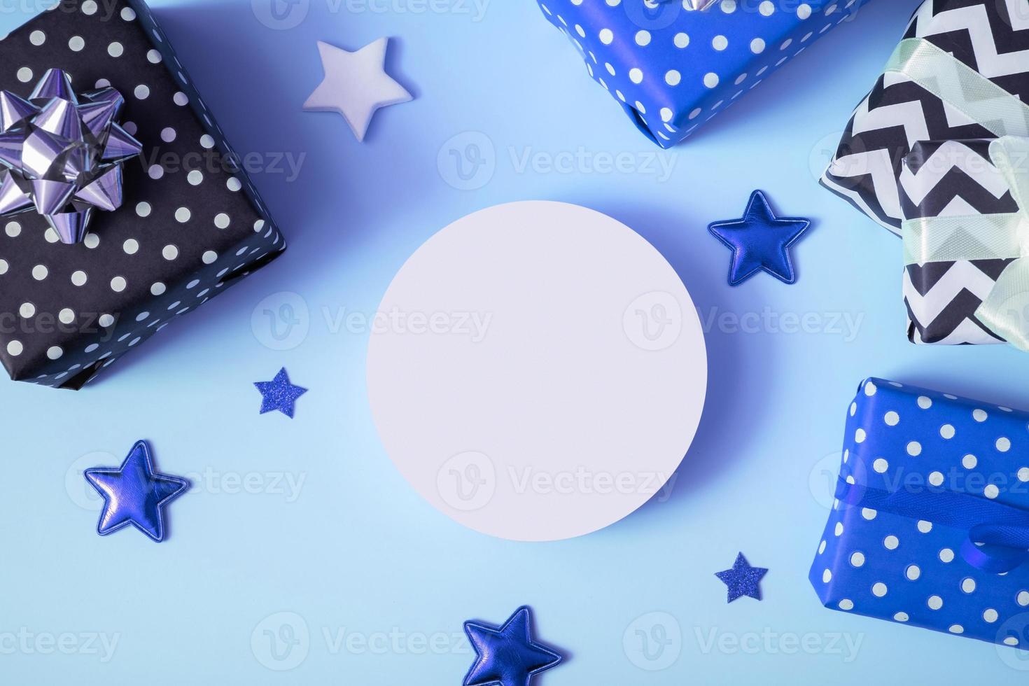 Product background for Christmas, New year and sale event concept. Gift boxes with ribbon bow on blue background top view photo