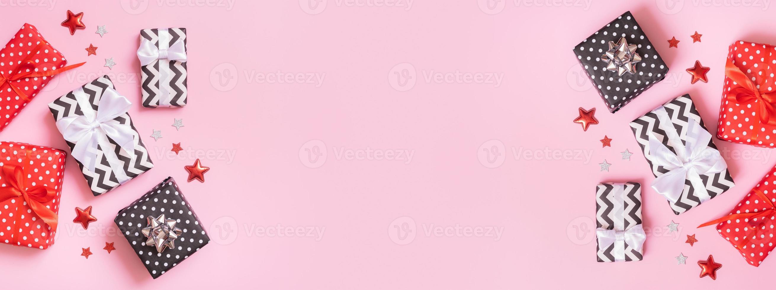 Banner with Christmas presents flat lay on a pink background. Top view xmas gifts with decorations photo