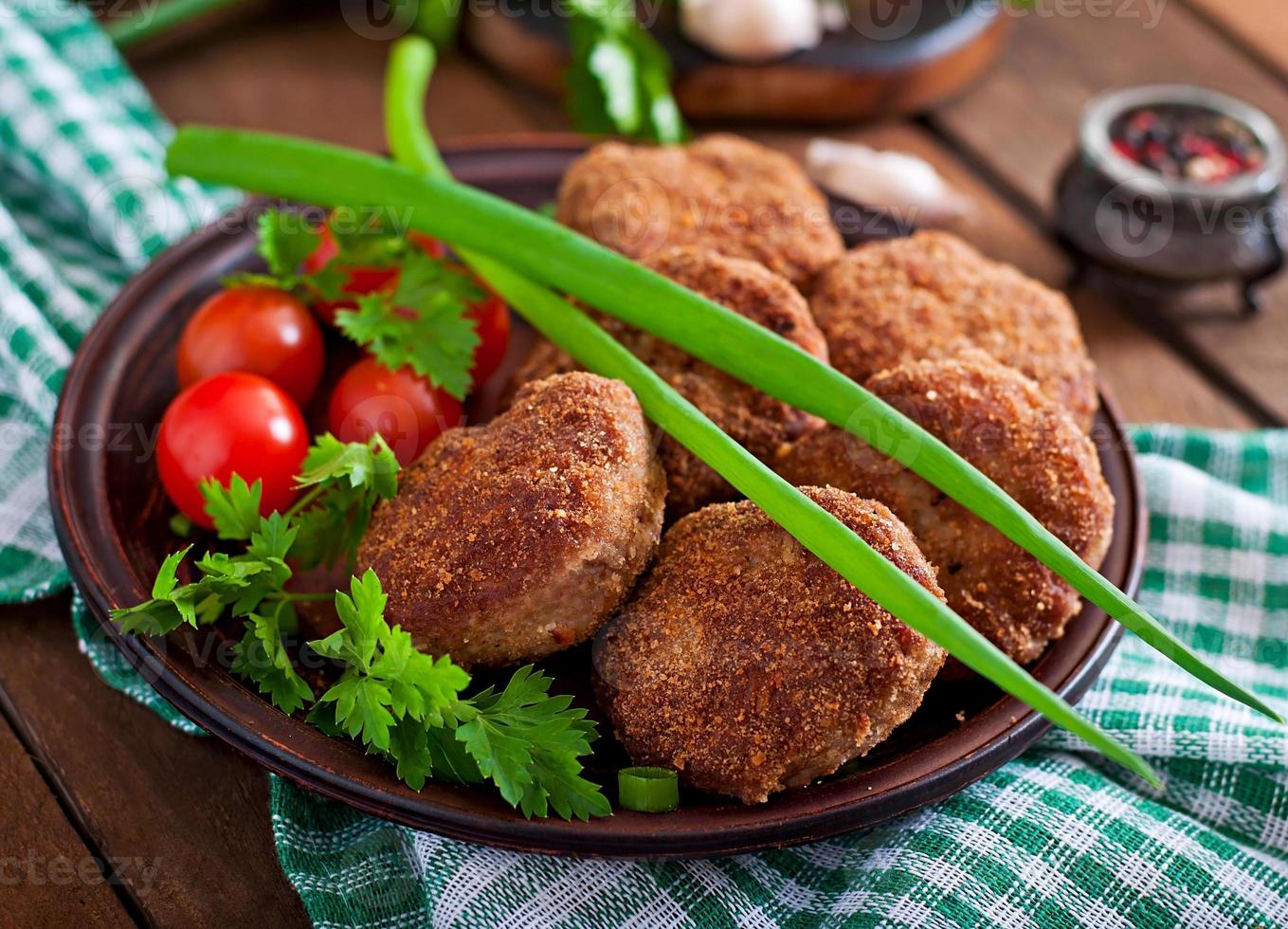 Juicy delicious meat cutlets on a wooden table in a rustic style. photo