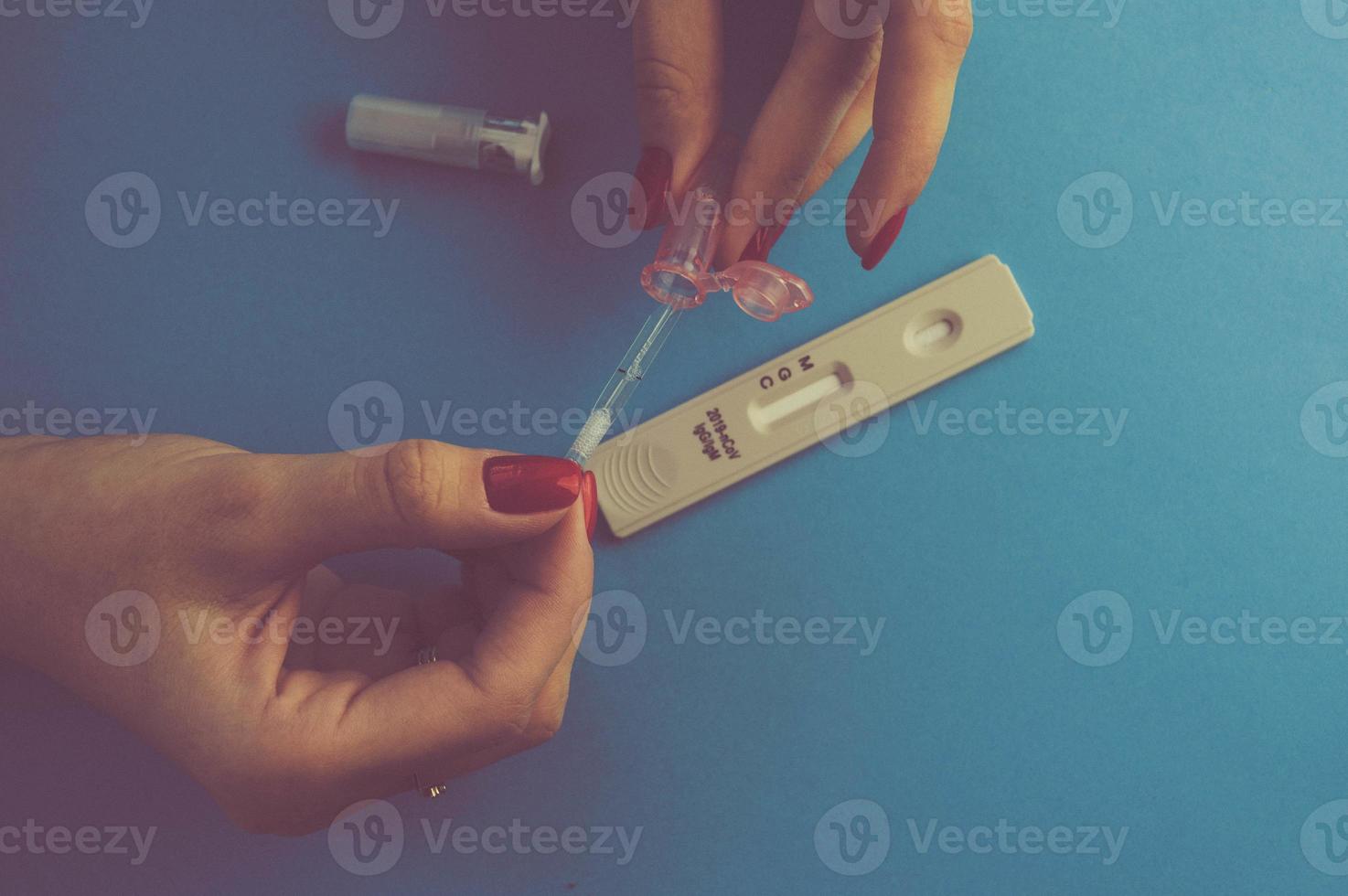 a blood test to determine the coronavirus. home self-diagnosis. immunoblot. determination of IgG and IgM antibodies. a drop of blood is added to the test strip photo