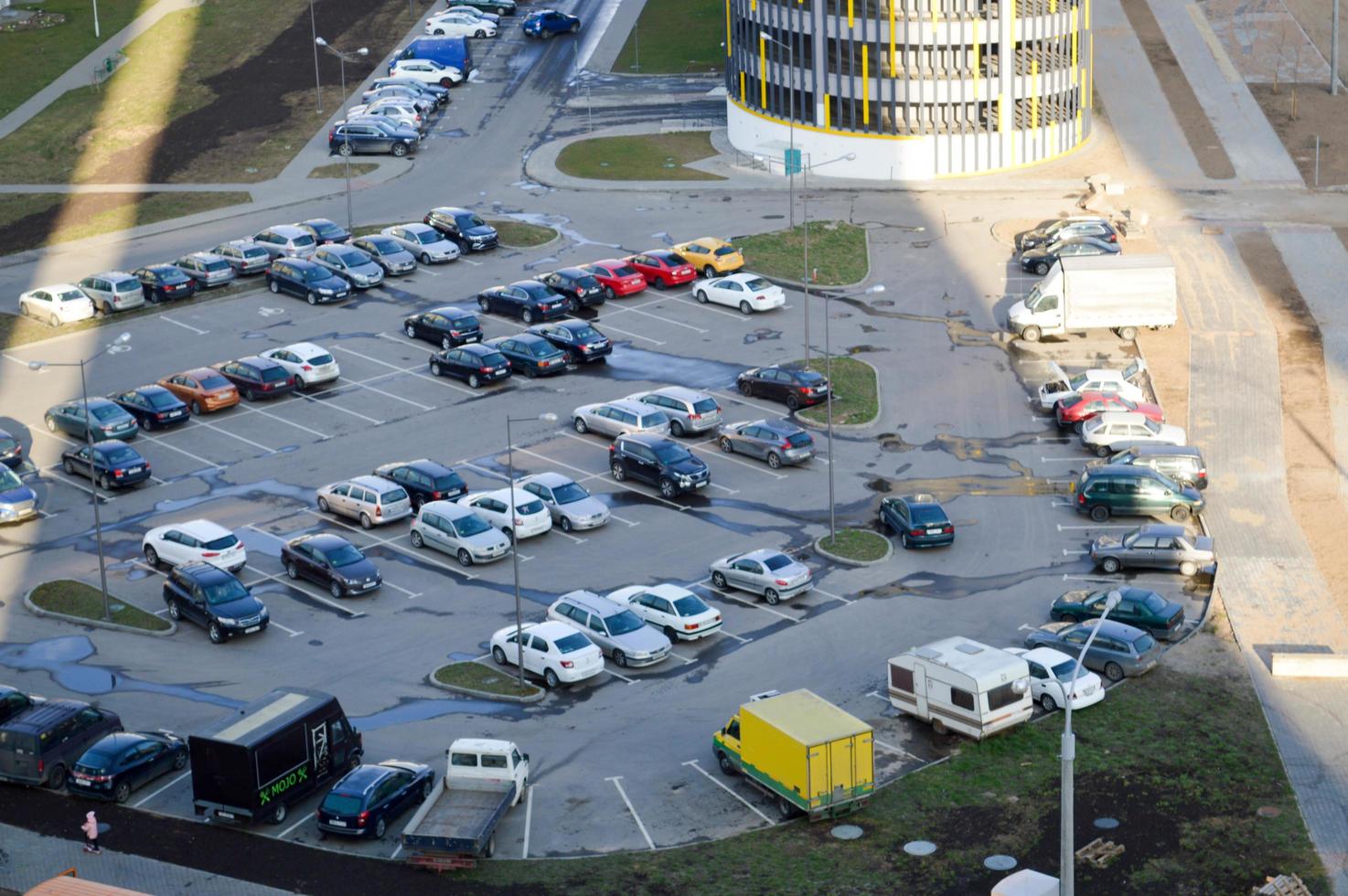 View from the top of a large open car parking and indoor multi-level parking in a residential area of the big city of the metropolis photo