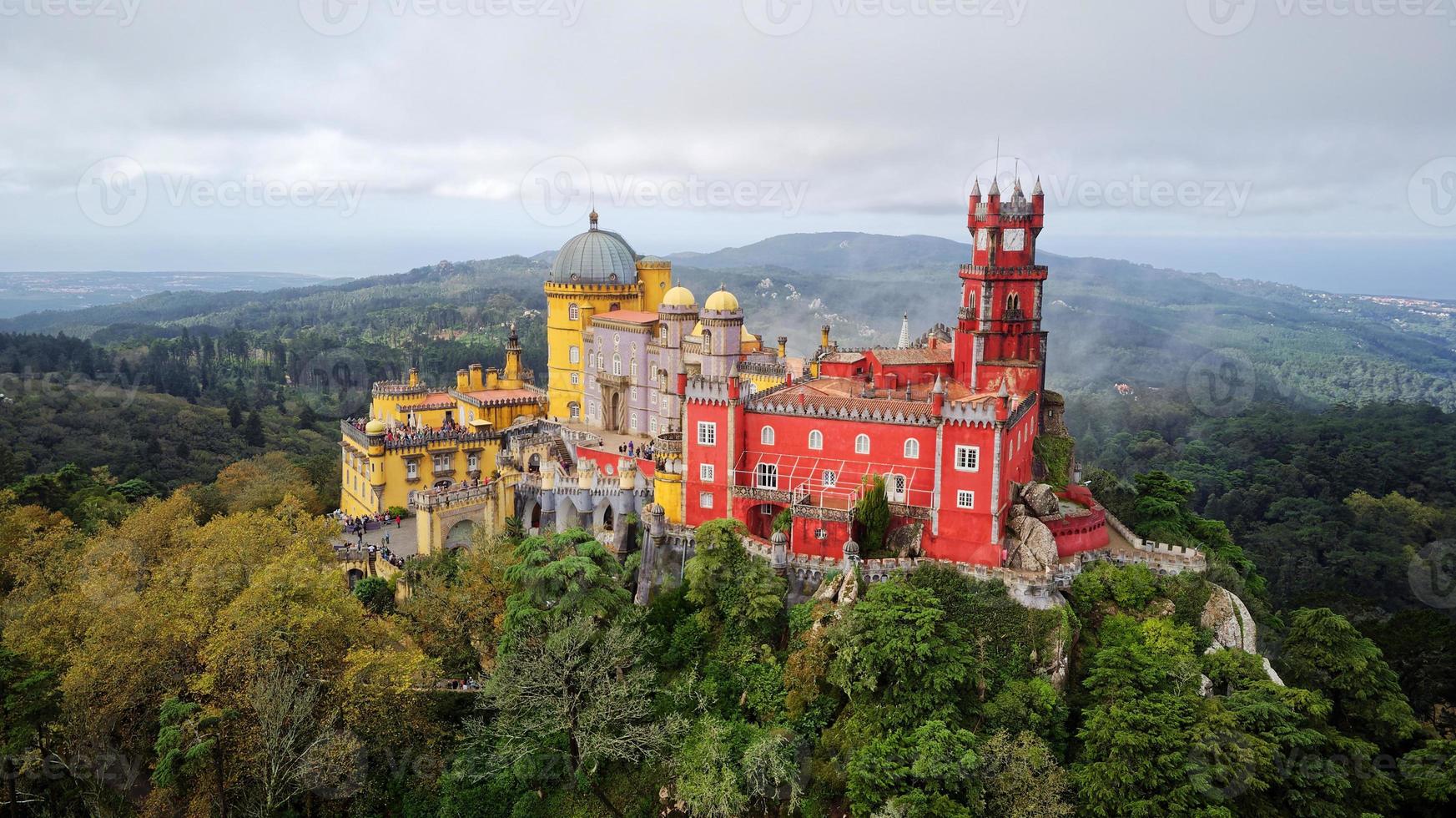 Aerial drone view of Park and National Palace of Pena in Sintra, Portugal during a magical day. Unesco. Historic visits. Sightseeing. Fairytale. Best destinations in the world. Most visited places. photo