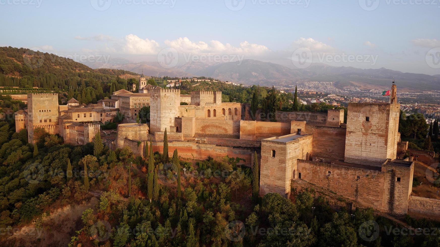 Aerial drone view of the Alhambra Palace, Granada during sunset. Moorish Architecture. Unesco World Heritage Spain. Travel in time and discover history. Amazing destinations for holidays. photo