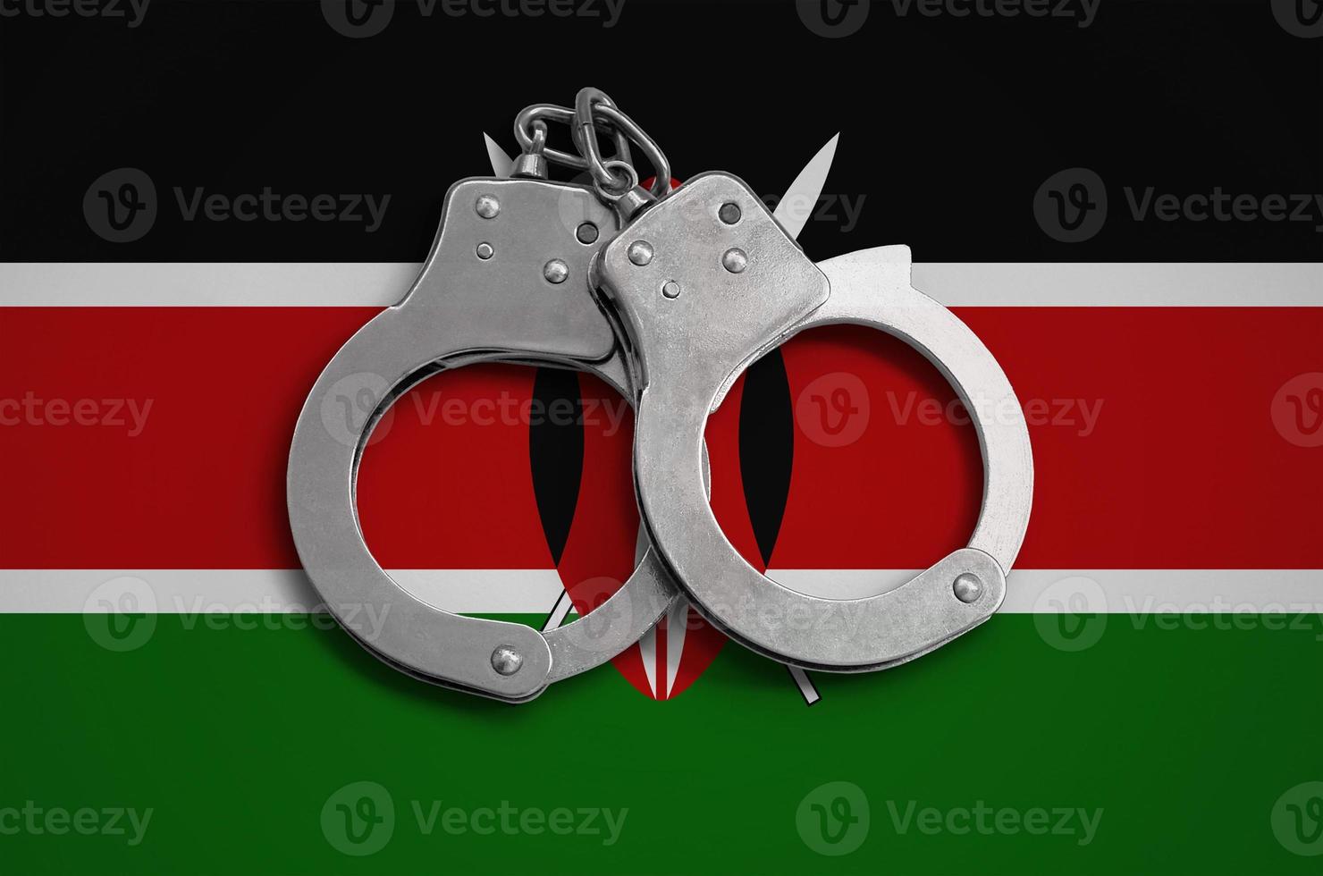 Kenya flag  and police handcuffs. The concept of observance of the law in the country and protection from crime photo