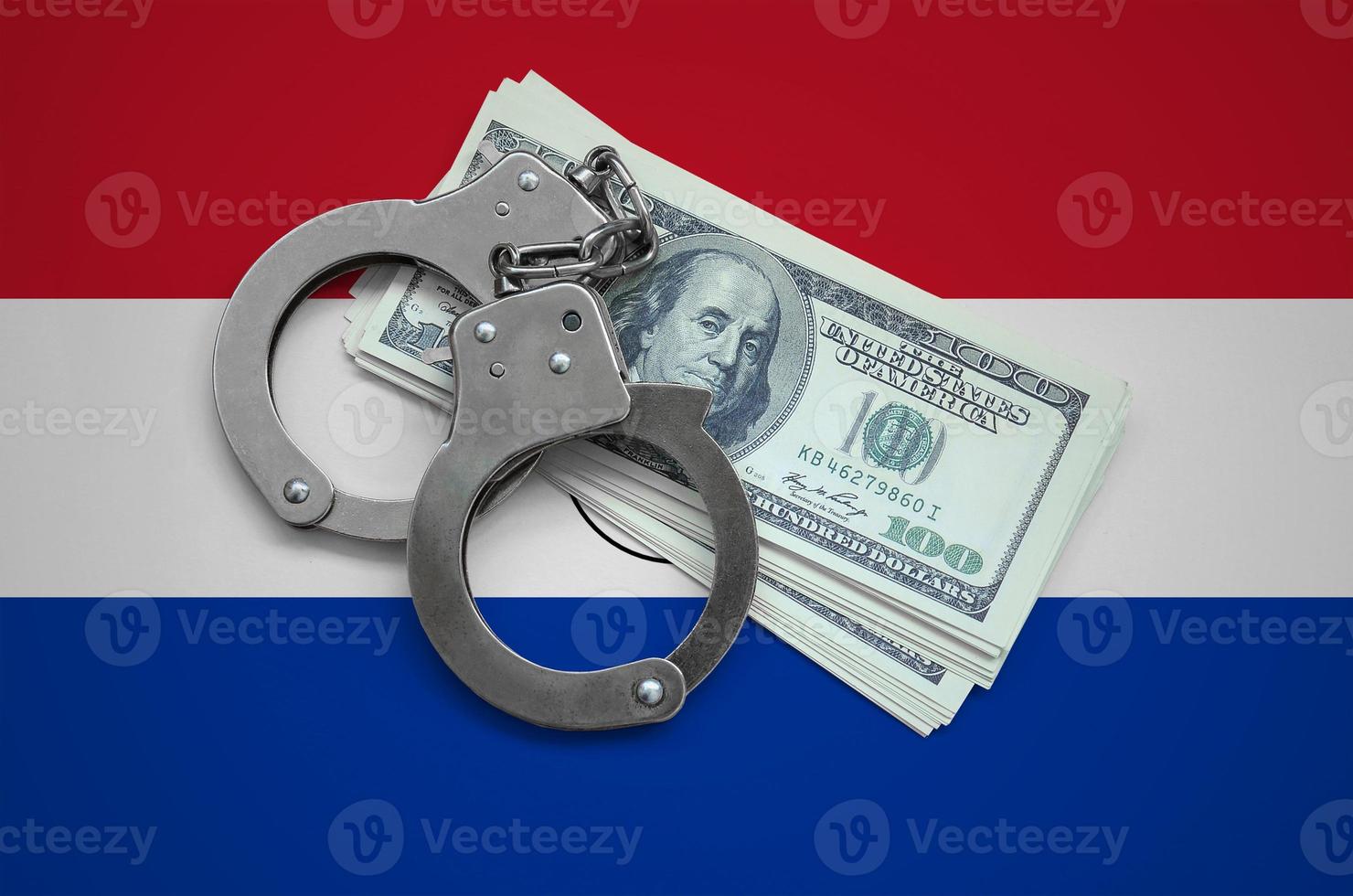 Paraguay flag  with handcuffs and a bundle of dollars. Currency corruption in the country. Financial crimes photo