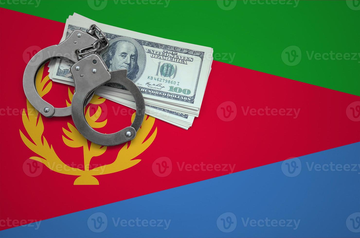 Eritrea flag  with handcuffs and a bundle of dollars. The concept of breaking the law and thieves crimes photo