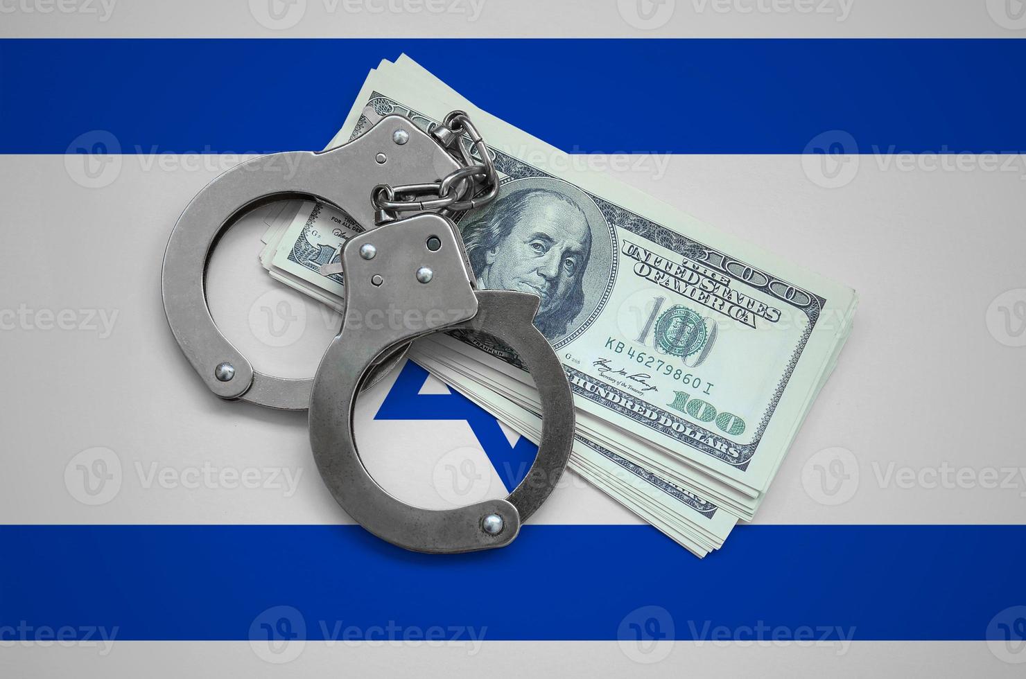 Israel flag  with handcuffs and a bundle of dollars. Currency corruption in the country. Financial crimes photo