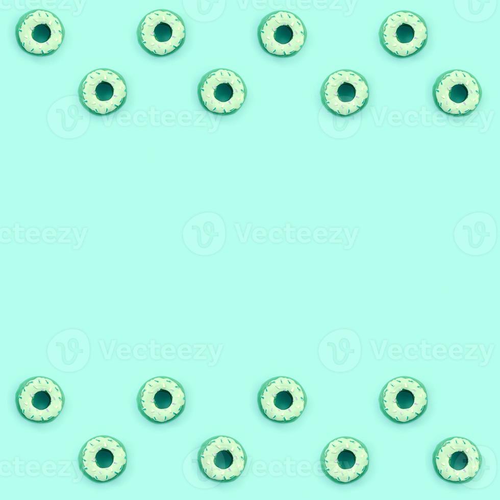 Many small plastic donuts lies on a pastel colorful background. Flat lay minimal pattern. Top view photo