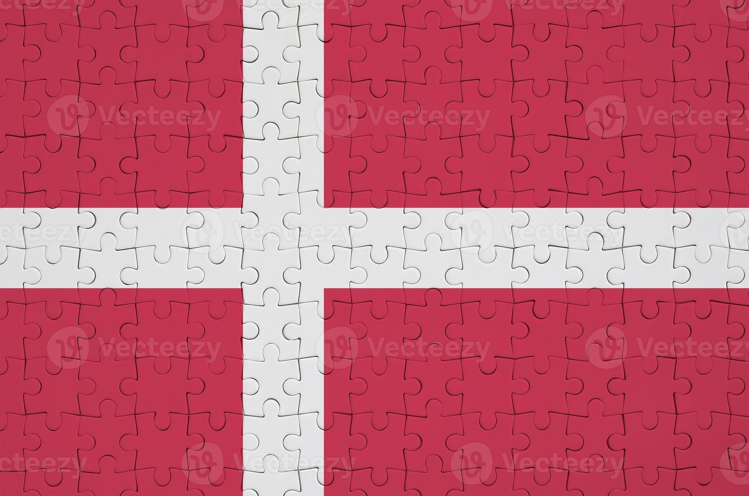 Denmark flag  is depicted on a folded puzzle photo