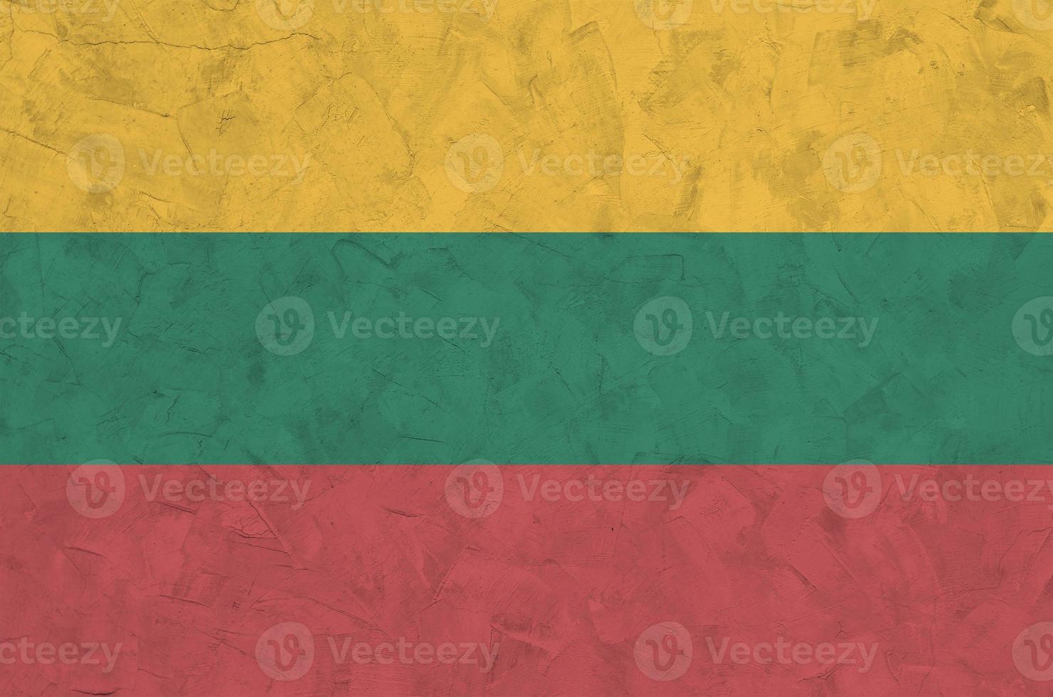 Lithuania flag depicted in bright paint colors on old relief plastering wall. Textured banner on rough background photo