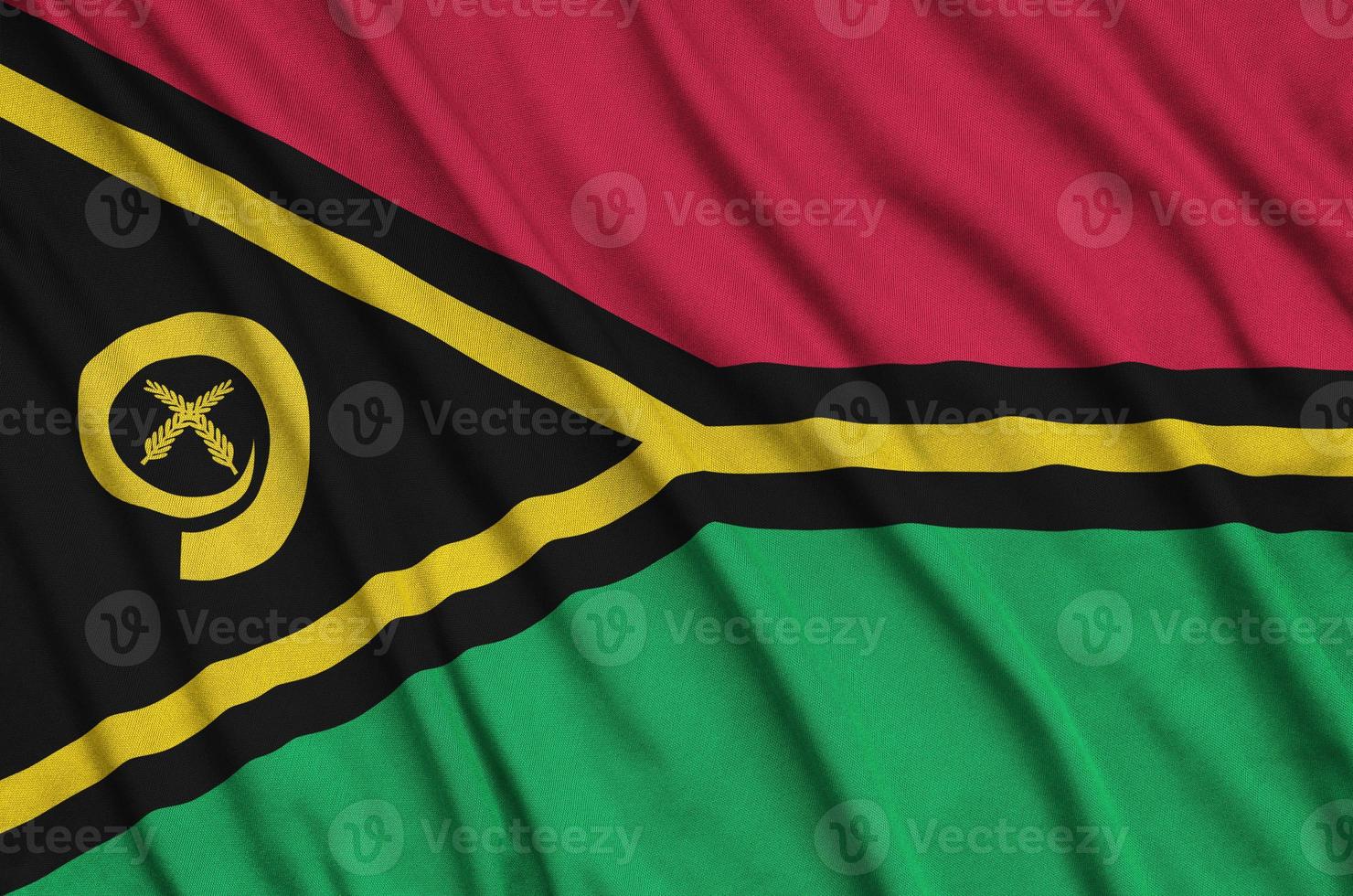 Vanuatu flag  is depicted on a sports cloth fabric with many folds. Sport team banner photo