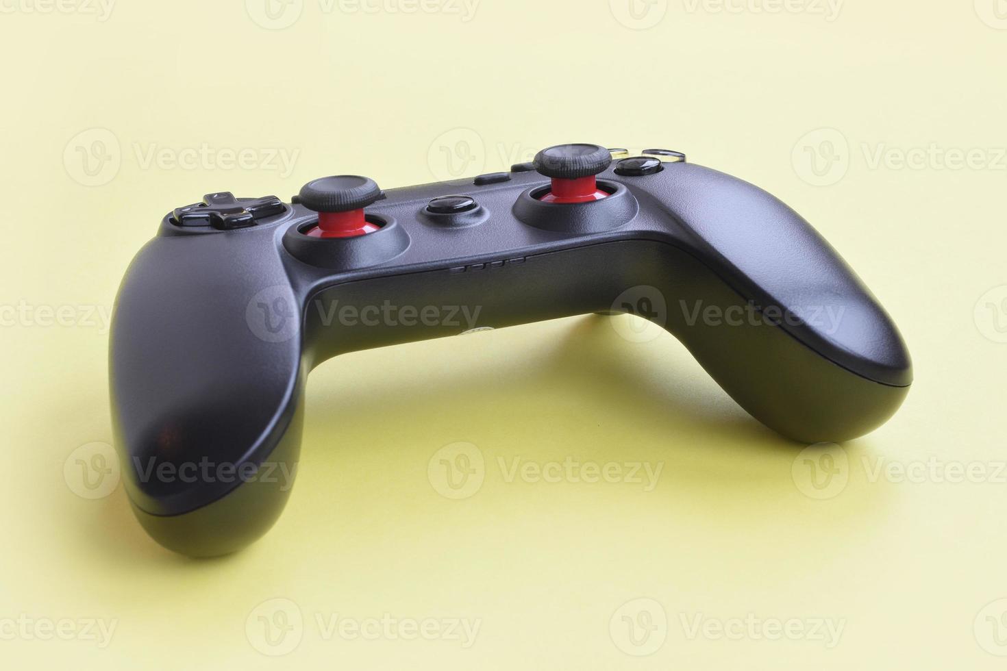 Modern black joystick on yellow background. Gameplay streaming and video game walkthroughts concept photo