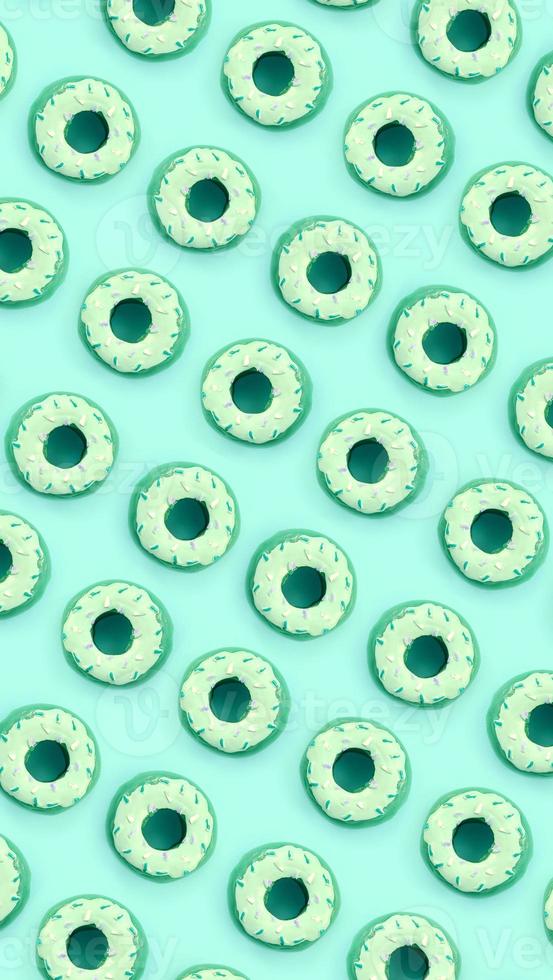Many small plastic donuts lies on a pastel colorful background. Flat lay minimal pattern. Top view photo
