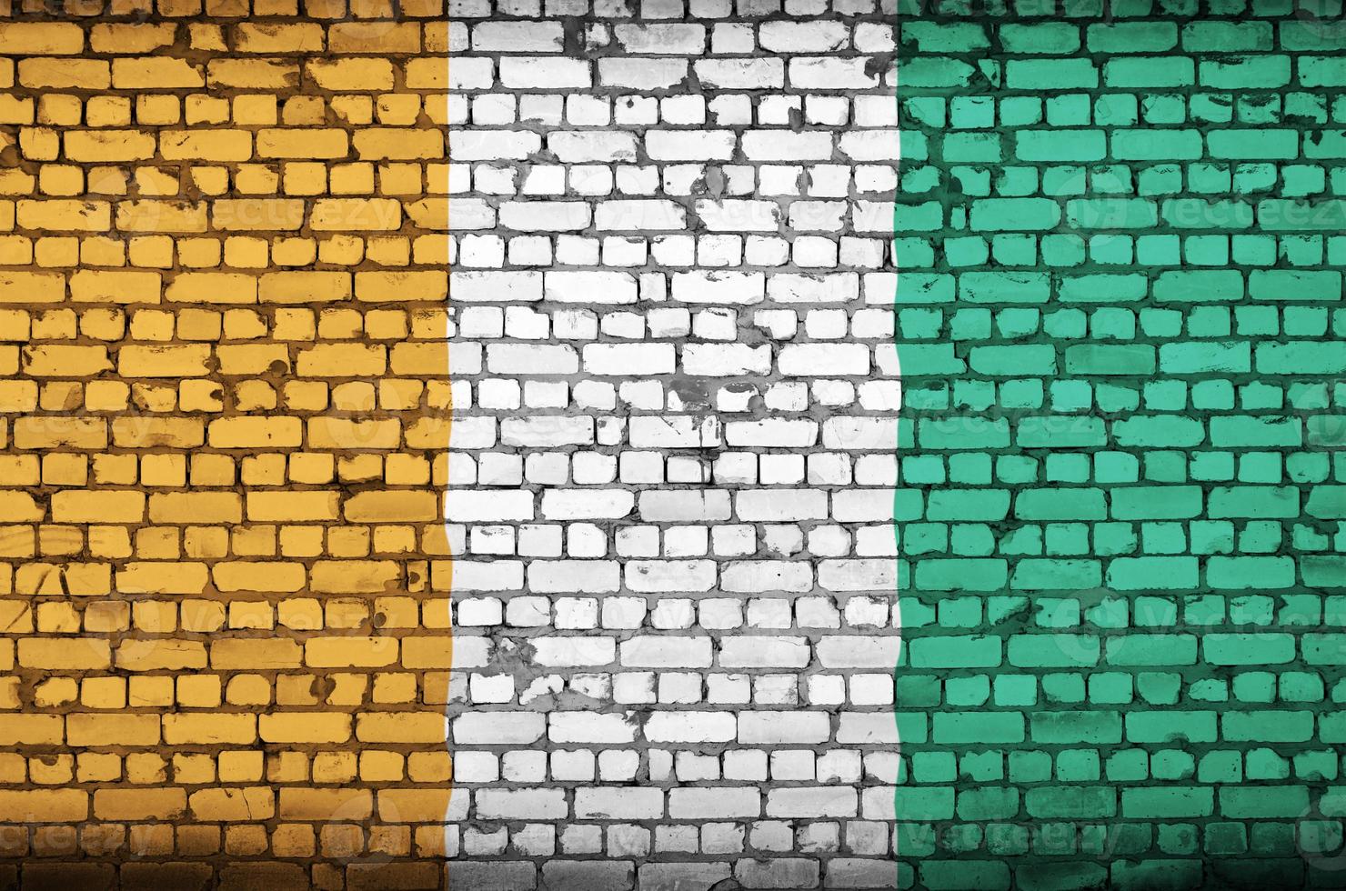 Ivory Coast flag is painted onto an old brick wall photo