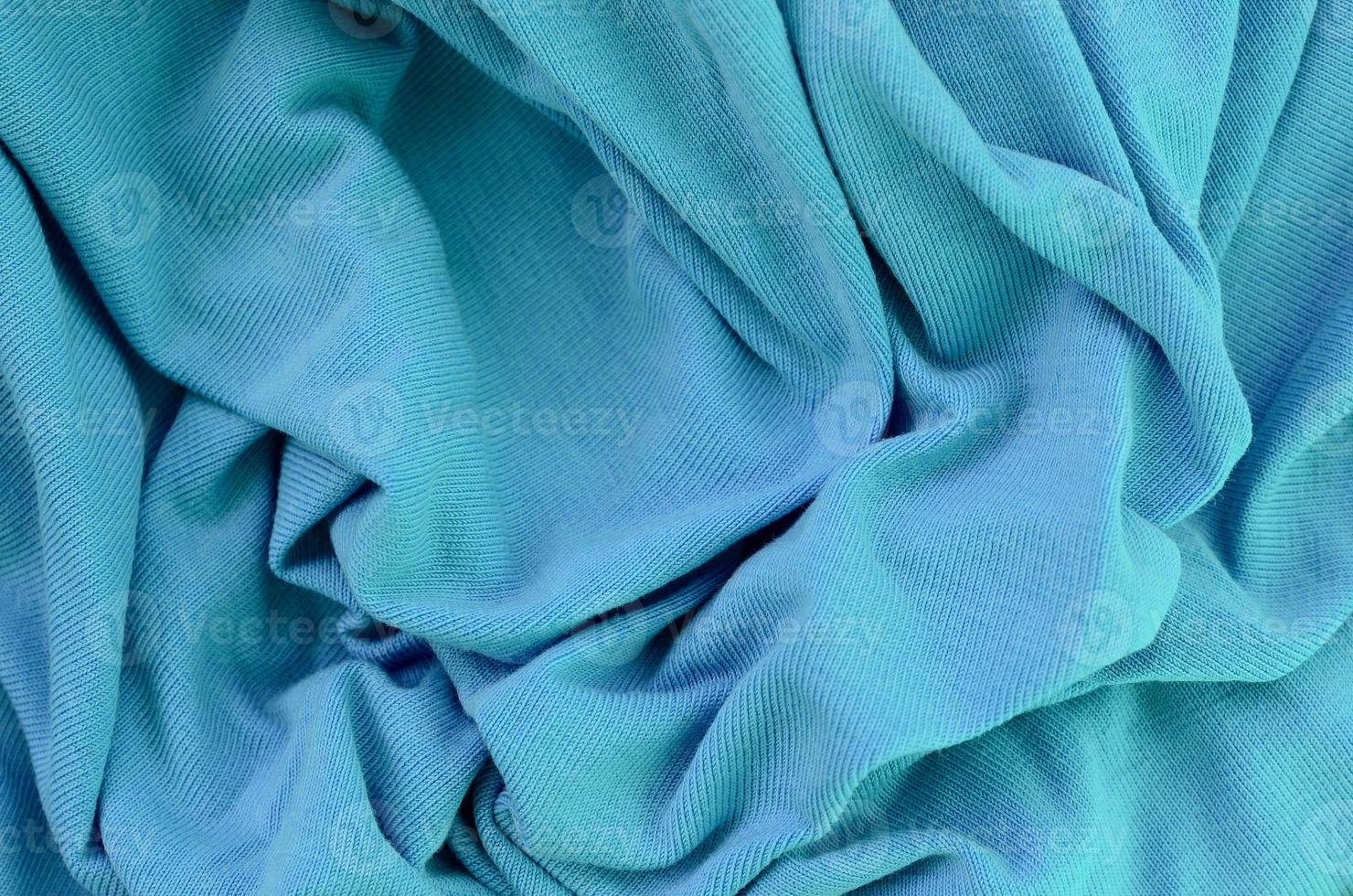 The texture of the fabric in blue color. Material for making shirts and blouses photo