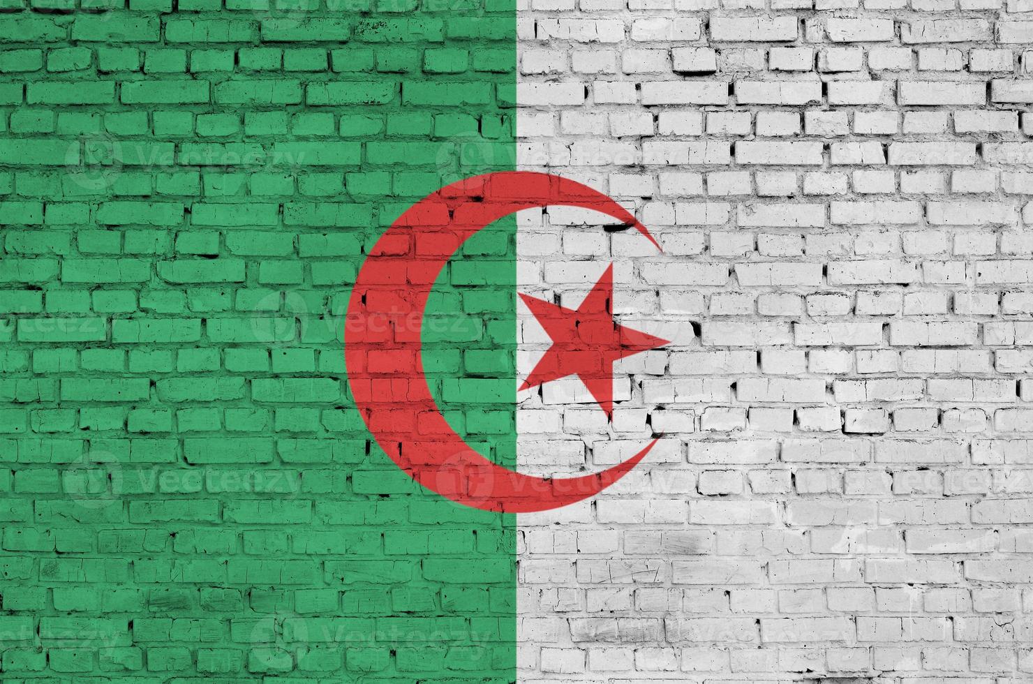 Algeria flag is painted onto an old brick wall photo