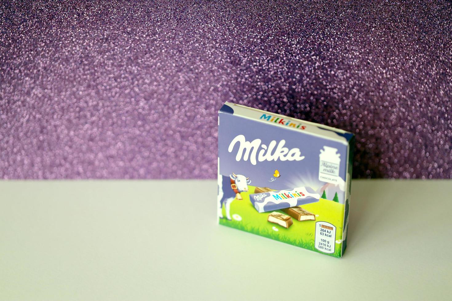 TERNOPIL, UKRAINE - JUNE 3, 2022 Milka milkinis small pack with chocolate finger bars. Milka is a Swiss brand of chocolate confection manufactured by company Mondelez International photo