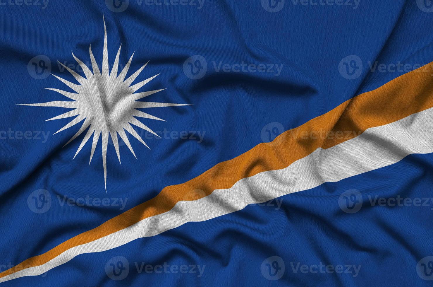 Marshall Islands flag  is depicted on a sports cloth fabric with many folds. Sport team banner photo