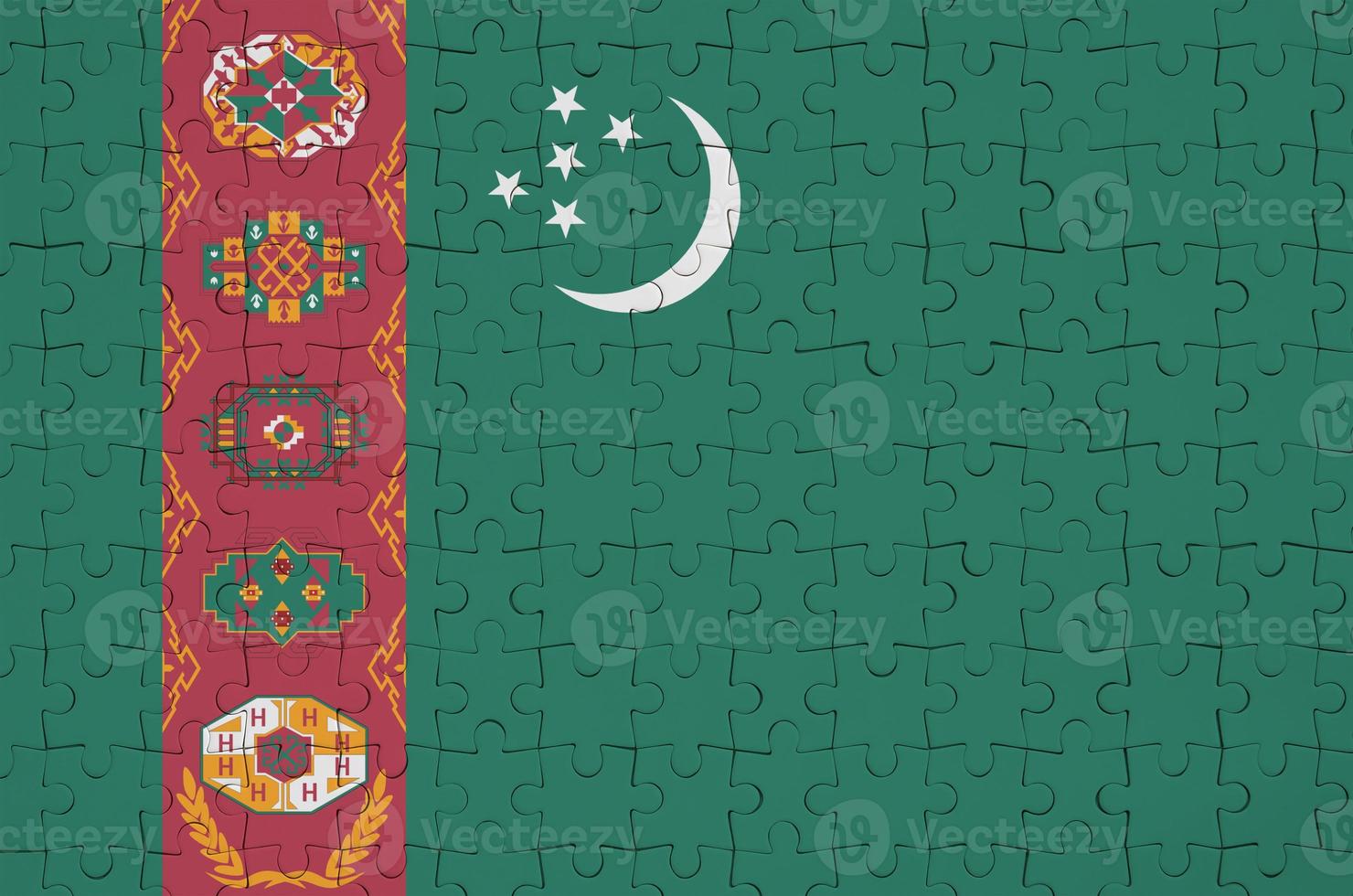 Turkmenistan flag  is depicted on a folded puzzle photo