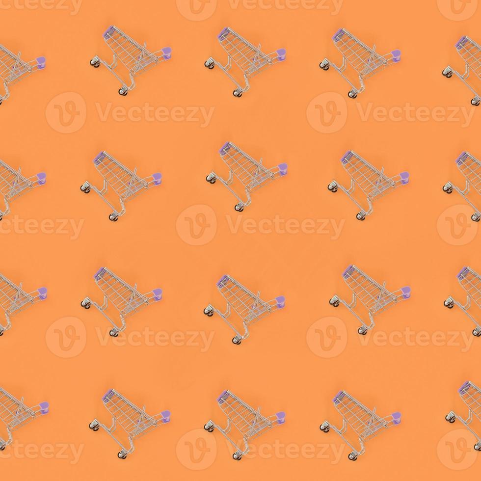 Shopping addiction, shopping lover or shopaholic concept. Many small empty shopping carts perform a pattern on a pastel colored paper background. Flat lay composition, top view photo