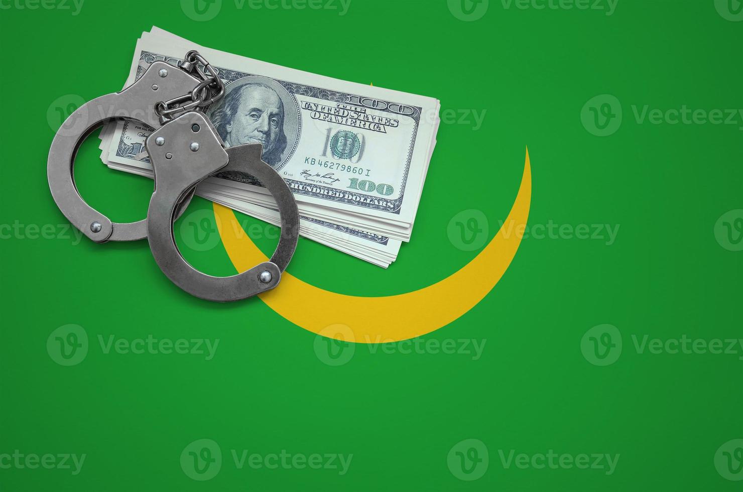 Mauritania flag  with handcuffs and a bundle of dollars. The concept of breaking the law and thieves crimes photo