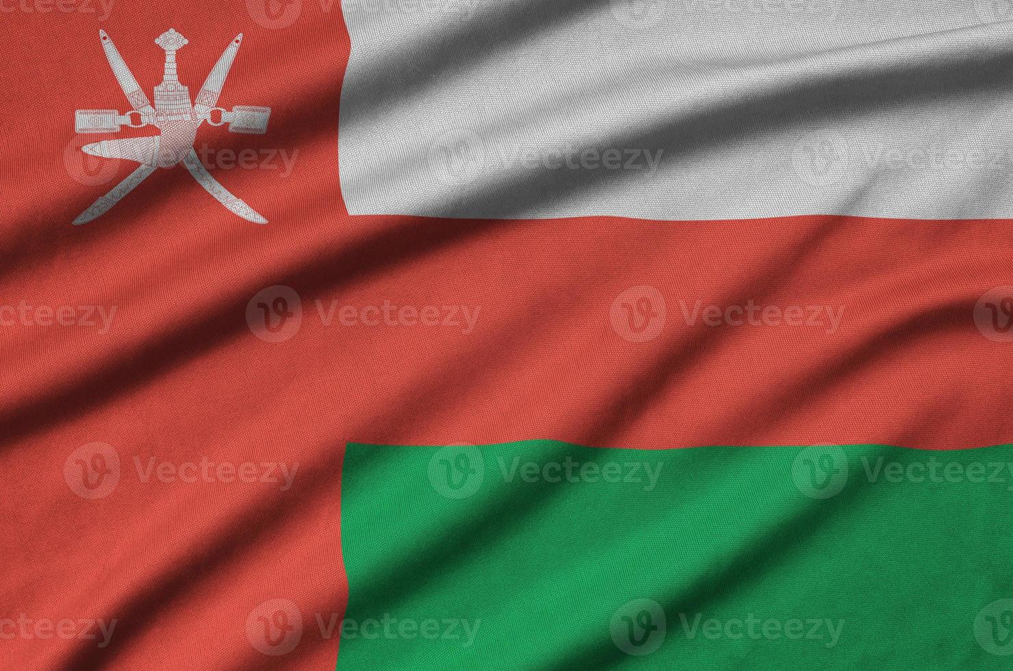 Oman flag  is depicted on a sports cloth fabric with many folds. Sport team banner photo