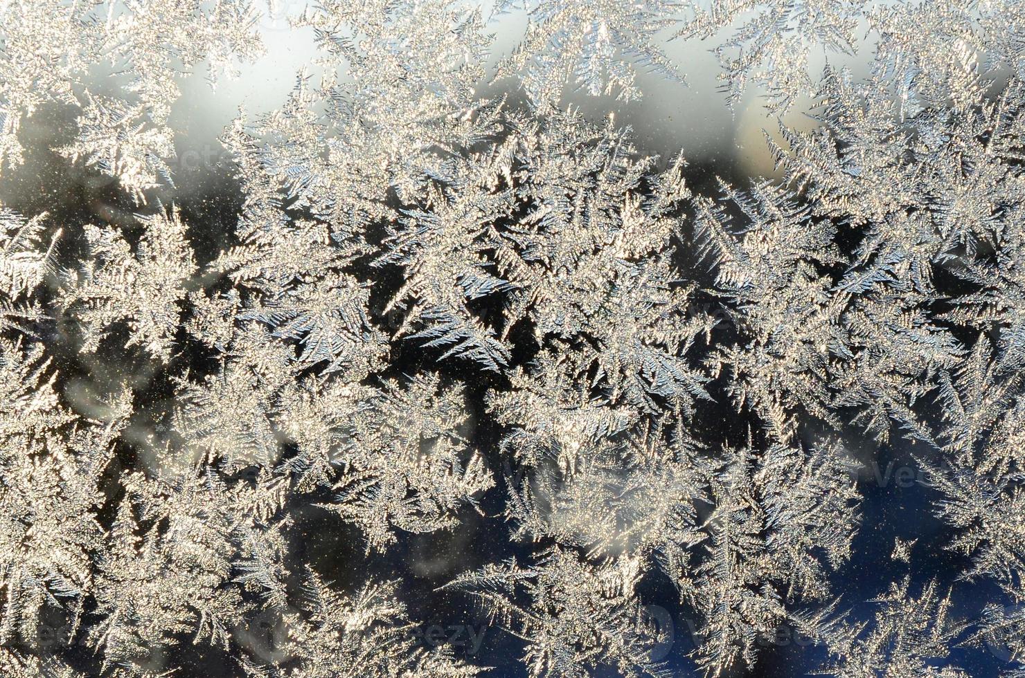 copos de nieve escarcha escarcha macro en el cristal de la ventana foto