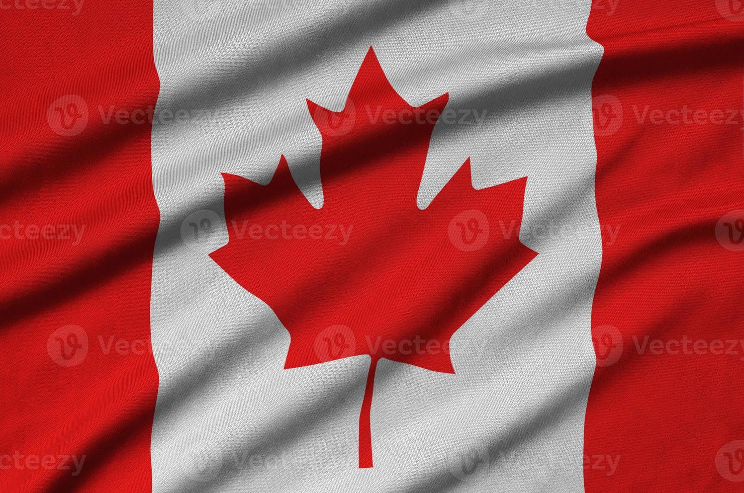 Canada flag  is depicted on a sports cloth fabric with many folds. Sport team banner photo