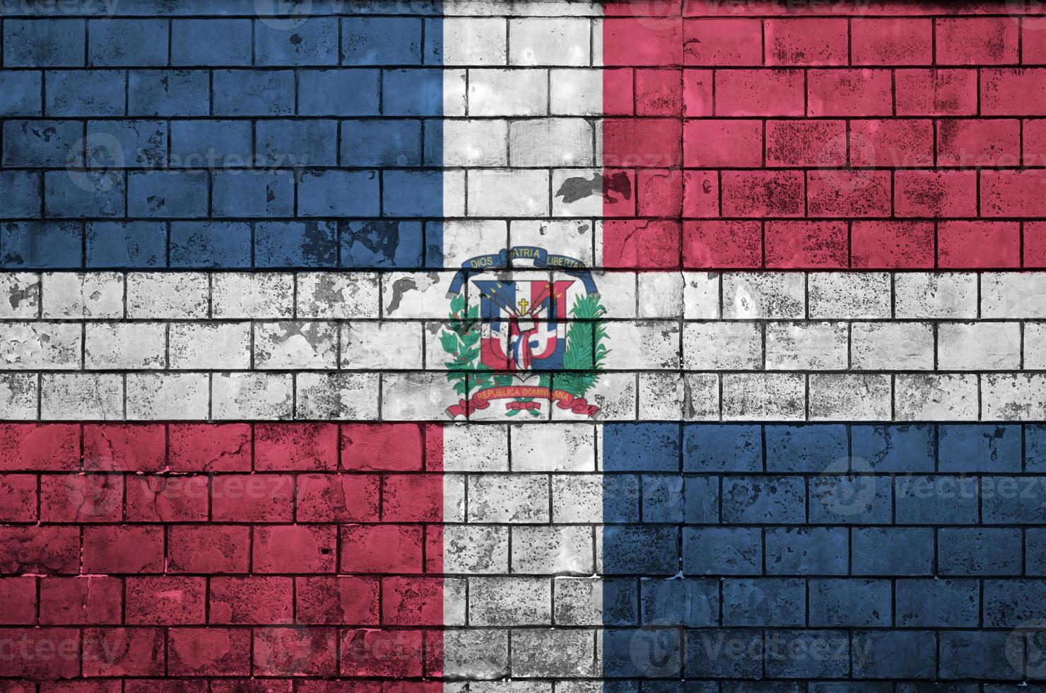 Dominican Republic flag is painted onto an old brick wall photo