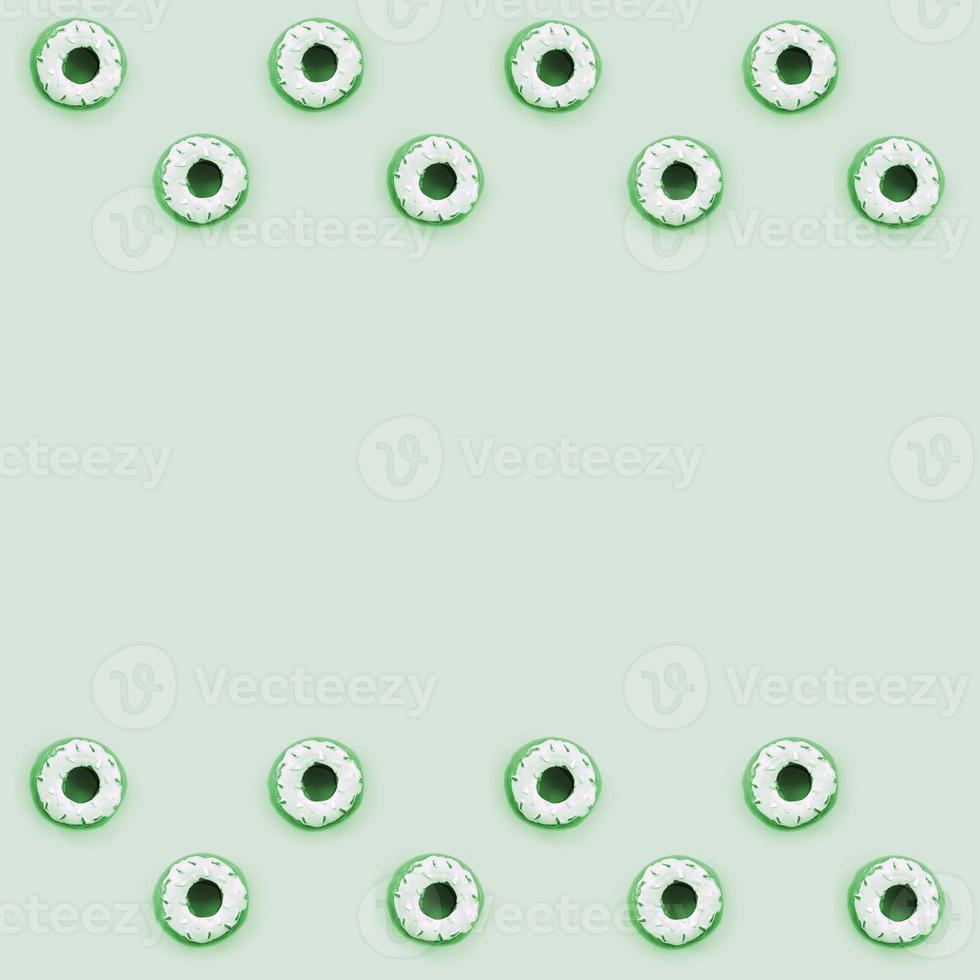 Many small plastic donuts lies on a pastel colorful background. Flat lay minimal pattern. Top view photo