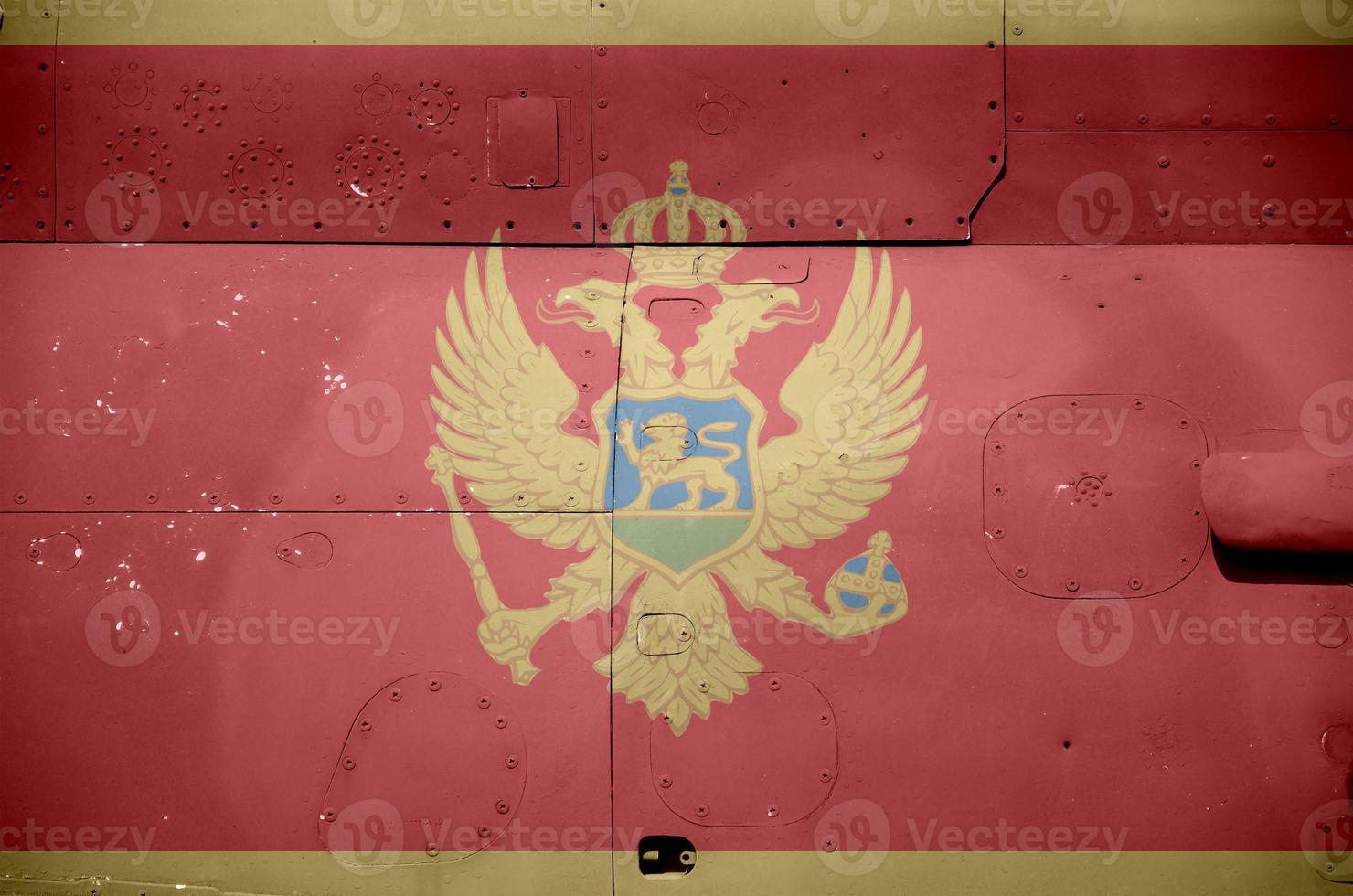 Montenegro flag depicted on side part of military armored helicopter closeup. Army forces aircraft conceptual background photo
