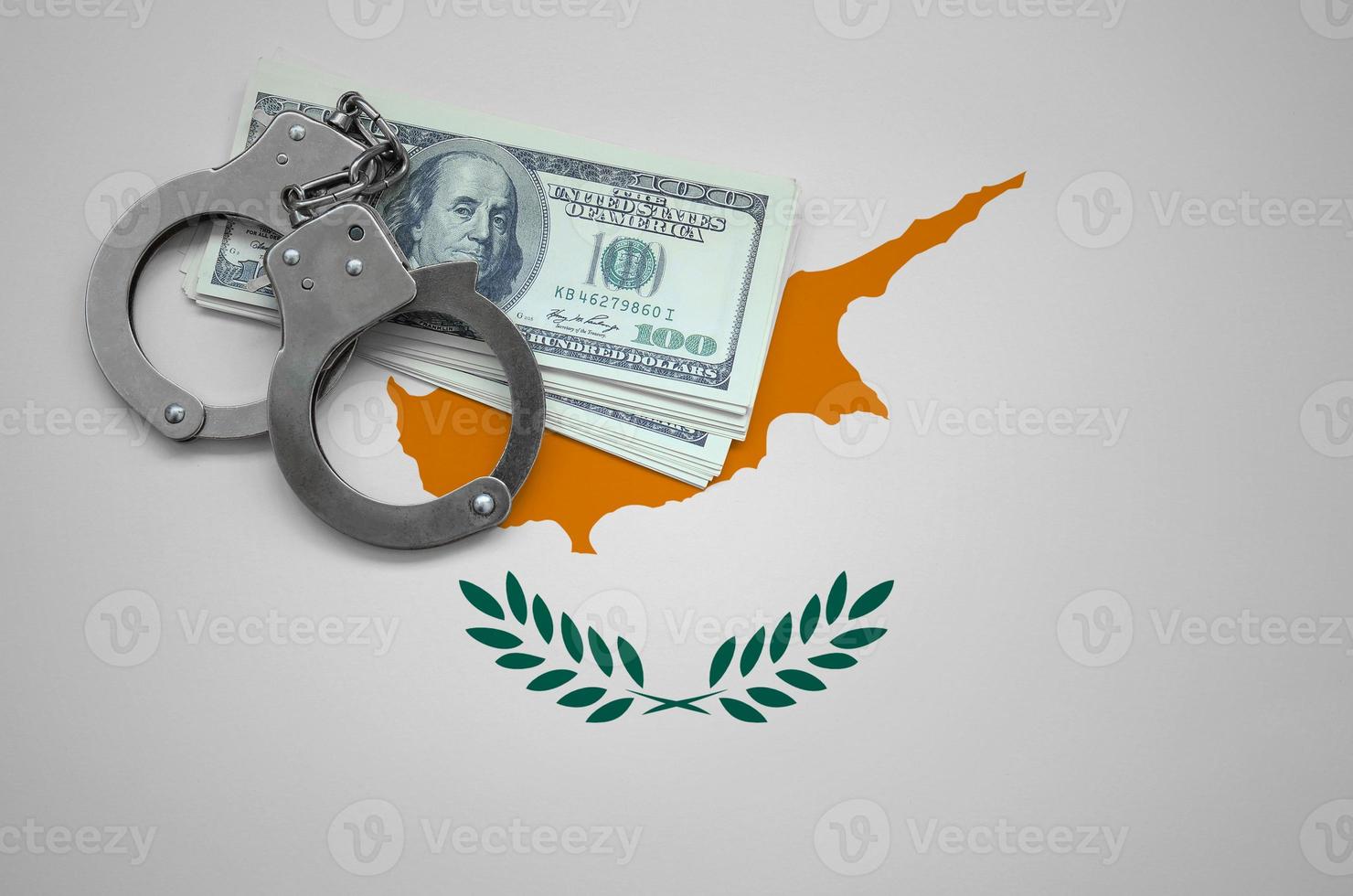 Cyprus flag  with handcuffs and a bundle of dollars. The concept of breaking the law and thieves crimes photo